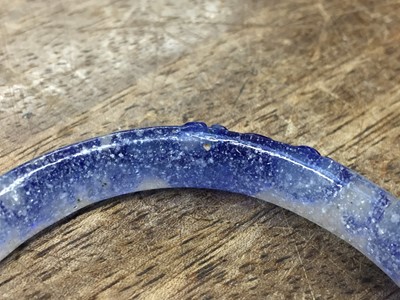 Lot 110 - A CHINESE BLUE-OVERLAY BEIJING GLASS 'CHILONG' BANGLE