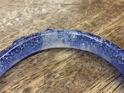 Lot 110 - A CHINESE BLUE-OVERLAY BEIJING GLASS 'CHILONG' BANGLE