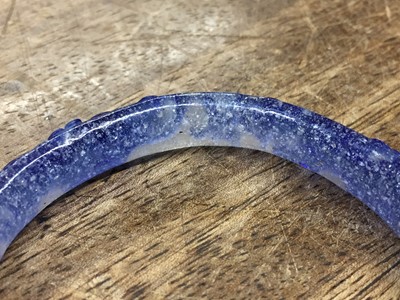 Lot 110 - A CHINESE BLUE-OVERLAY BEIJING GLASS 'CHILONG' BANGLE