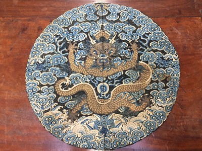 Lot 591 - A CHINESE SILK EMBROIDERED MIDNIGHT-BLUE 'DRAGON' ROUNDEL, BUZI
