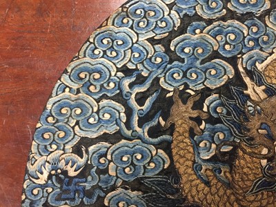 Lot 591 - A CHINESE SILK EMBROIDERED MIDNIGHT-BLUE 'DRAGON' ROUNDEL, BUZI