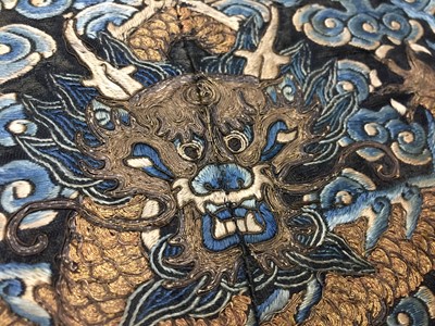 Lot 591 - A CHINESE SILK EMBROIDERED MIDNIGHT-BLUE 'DRAGON' ROUNDEL, BUZI