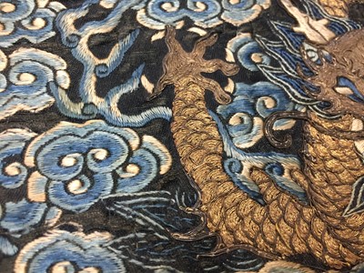 Lot 591 - A CHINESE SILK EMBROIDERED MIDNIGHT-BLUE 'DRAGON' ROUNDEL, BUZI