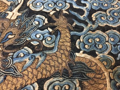 Lot 591 - A CHINESE SILK EMBROIDERED MIDNIGHT-BLUE 'DRAGON' ROUNDEL, BUZI