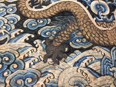 Lot 591 - A CHINESE SILK EMBROIDERED MIDNIGHT-BLUE 'DRAGON' ROUNDEL, BUZI