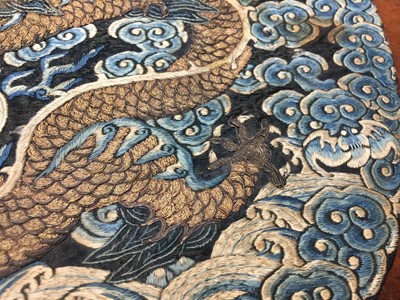 Lot 591 - A CHINESE SILK EMBROIDERED MIDNIGHT-BLUE 'DRAGON' ROUNDEL, BUZI