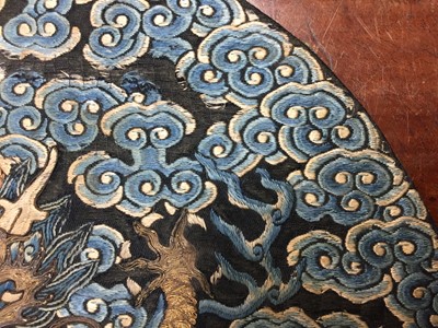 Lot 591 - A CHINESE SILK EMBROIDERED MIDNIGHT-BLUE 'DRAGON' ROUNDEL, BUZI