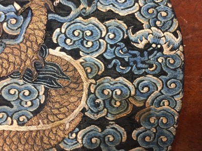 Lot 591 - A CHINESE SILK EMBROIDERED MIDNIGHT-BLUE 'DRAGON' ROUNDEL, BUZI