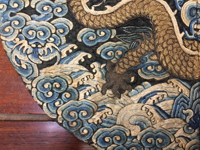Lot 591 - A CHINESE SILK EMBROIDERED MIDNIGHT-BLUE 'DRAGON' ROUNDEL, BUZI