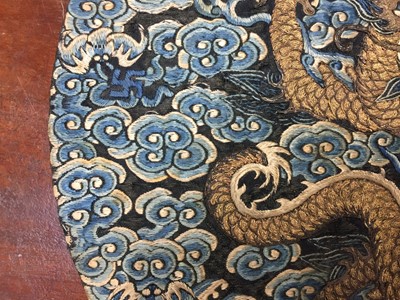 Lot 591 - A CHINESE SILK EMBROIDERED MIDNIGHT-BLUE 'DRAGON' ROUNDEL, BUZI