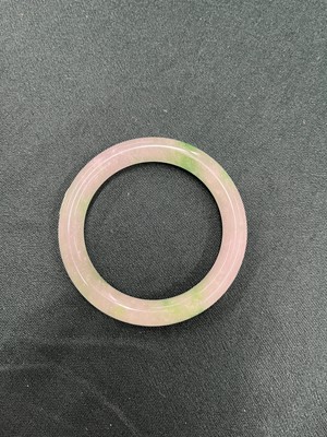 Lot 734 - A CHINESE PALE-CELADON AND APPLE-GREEN JADE BANGLE