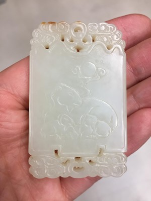 Lot 514 - A CHINESE PALE-CELADON JADE 'THREE RAMS' PLAQUE
