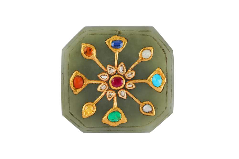 Lot 296 - A KUNDAN-SET NINE-GEM (NAVRATNA) CARVED JADE AMULET