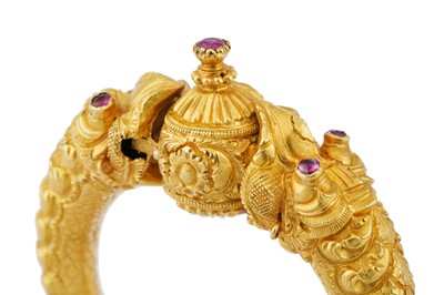 Lot 298 - A RUBY-SET 'MAKARA HEAD' GOLD BANGLE (KADA)