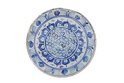 Lot 387 - AN IZNIK BLUE AND WHITE POTTERY DISH WITH SPIRAL DESIGN