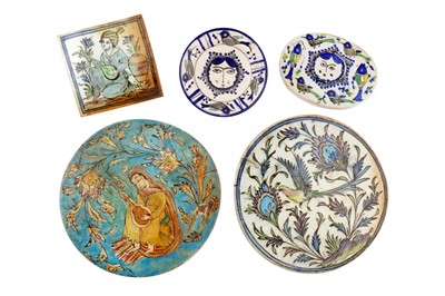 Lot 307 - FOUR QAJAR-REVIVAL POLYCHROME-PAINTED POTTERY TILES AND A LATE QAJAR POTTERY DISH