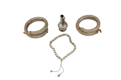 Lot 476 - THREE BEDOUIN WHITE METAL AND CORAL TALISMANIC ACCESSORIES