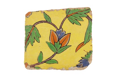 Lot 282 - A FRAGMENT OF A MUGHAL CUERDA SECA FLORAL POTTERY TILE