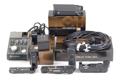 Lot 72 - A Group of Olympus Motor Drives & Chargers.
