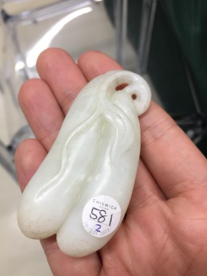 Lot 581 - A CHINESE PALE-CELADON JADE 'WINTER MELON' CARVING AND A HARDSTONE 'FISH' CARVING