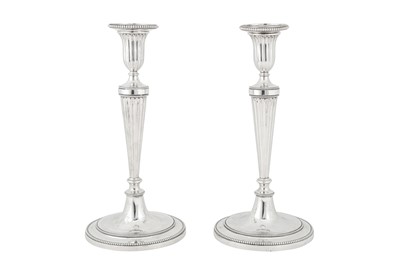 Lot 399 - A pair of Victorian sterling silver candlesticks, London 1880 by Martin Hall and Co