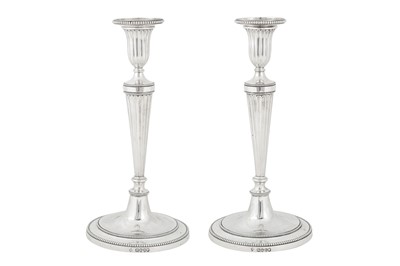 Lot 399 - A pair of Victorian sterling silver candlesticks, London 1880 by Martin Hall and Co