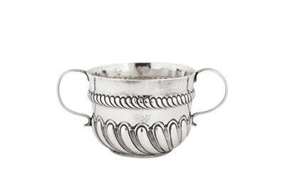 Lot 529 - A William and Mary sterling silver twin handled caudle cup, London 1691 by I.N in an oval