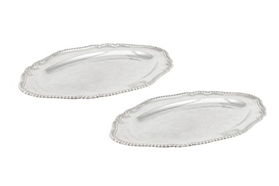 Lot 517 - A pair of George II sterling silver meat dishes, London 1754 by William Cripps (first reg. 31st Aug 1743)