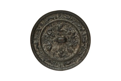 Lot 518 - A CHINESE BRONZE 'LIONS AND GRAPES' MIRROR