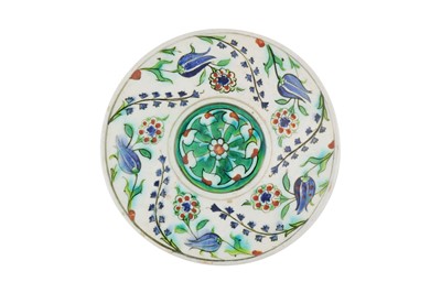 Lot 390 - AN IZNIK POTTERY SAUCER WITH TULIPS, ROSETTES, AND BLUE HYACINTHS