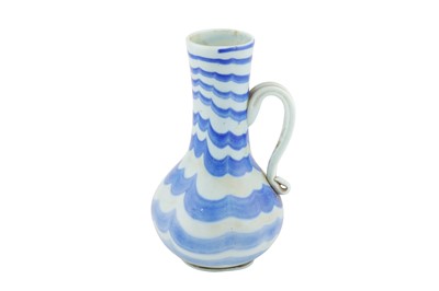 Lot 388 - AN OPALESCENT WHITE AND BLUE MARVERED GLASS JUG