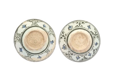 Lot 4 - A NEAR PAIR OF COBALT BLUE AND BLACK-PAINTED POTTERY BOWLS WITH ARABESQUE MOTIFS