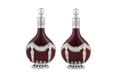 Lot 278 - A pair of late 19th century German 800 standard silver mounded ruby glass decanters, Kesselstadt circa 1890 by Karl Kurz
