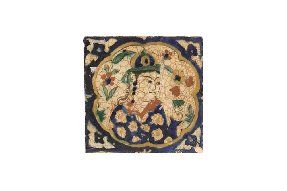 Lot 226 - A KUBACHI FIGURAL POTTERY TILE OF A PERSIAN YOUTH WITH A DRINKING CUP