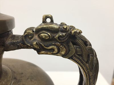 Lot 361 - A TIBETAN BRONZE EWER AND COVER