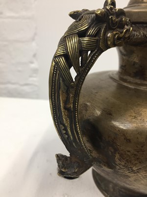 Lot 361 - A TIBETAN BRONZE EWER AND COVER