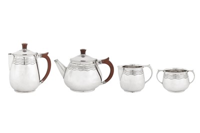 Lot 337 - A George V ‘Arts and Crafts’ sterling silver four-piece tea and coffee service, Birmingham 1935 by Arthur Matthews