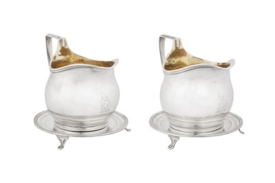 Lot 444 - A highly unusual and rare pair of George III provincial sterling silver milk jugs or sauce boats on stands, York 1802 by Hampston, Prince and Cattle