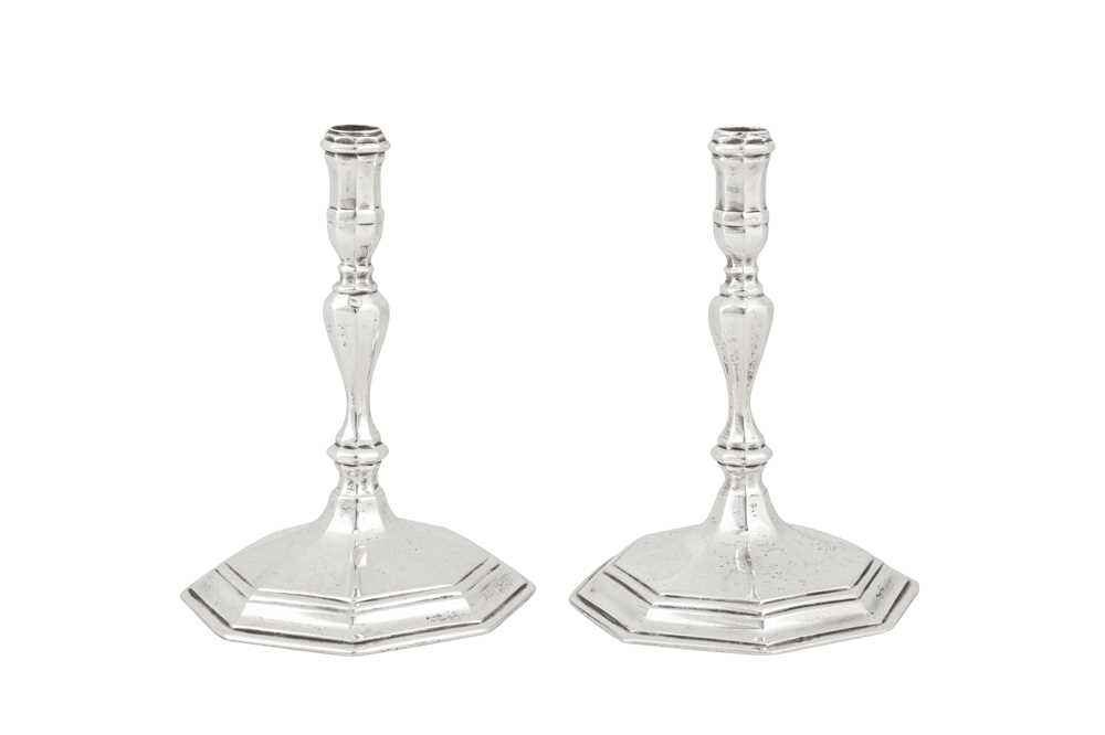 Lot 359 - A pair of George V sterling silver cast tapersticks, London 1933 by Richard Comyns
