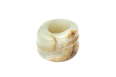 Lot 590 - A CHINESE CELADON JADE 'LOTUS' ARCHER'S RING
