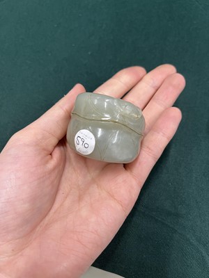 Lot 590 - A CHINESE CELADON JADE 'LOTUS' ARCHER'S RING