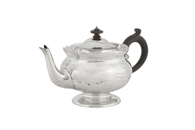 Lot 331 - An Edwardian ‘Arts and Crafts’ sterling silver teapot, London 1902 by Mappin and Webb