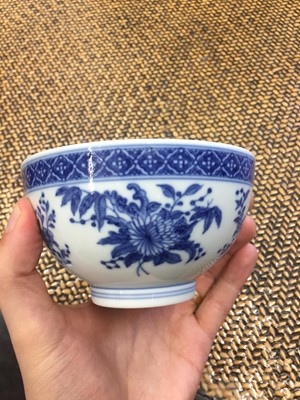Lot 599 - A CHINESE BLUE AND WHITE 'FLOWERS AND PEACHES' BOWL