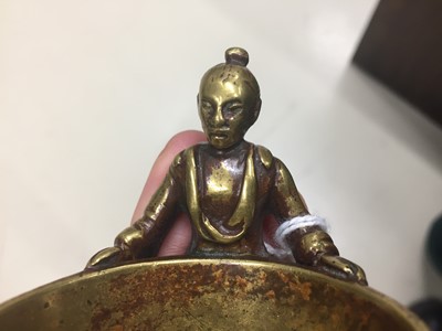 Lot 531 - A CHINESE GILT-BRONZE SCROLL WEIGHT AND A POLISHED-BRONZE CUP