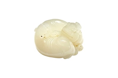 Lot 587 - A CHINESE PALE-CELADON JADE 'LION DOGS' GROUP