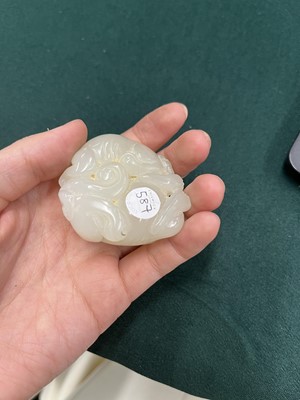 Lot 587 - A CHINESE PALE-CELADON JADE 'LION DOGS' GROUP