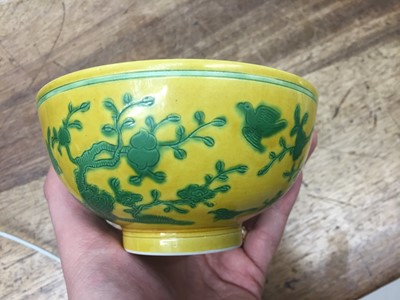 Lot 33 - A CHINESE YELLOW-GROUND 'BIRDS AND PEACHES' BOWL