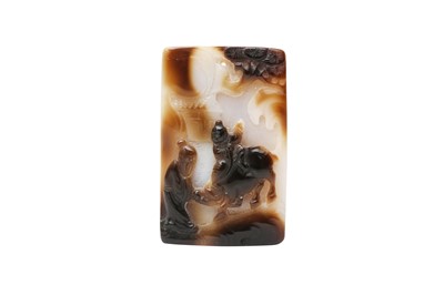 Lot 539 - A CHINESE CARVED AGATE 'BOY AND OX' PENDANT