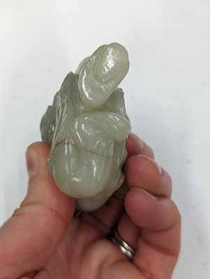 Lot 429 - A CHINESE CELADON JADE CARVING OF A MAN AND CHILD