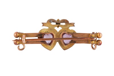Lot 54 - AN AMETHYST AND HALF PEARL SWEETHEART BROOCH